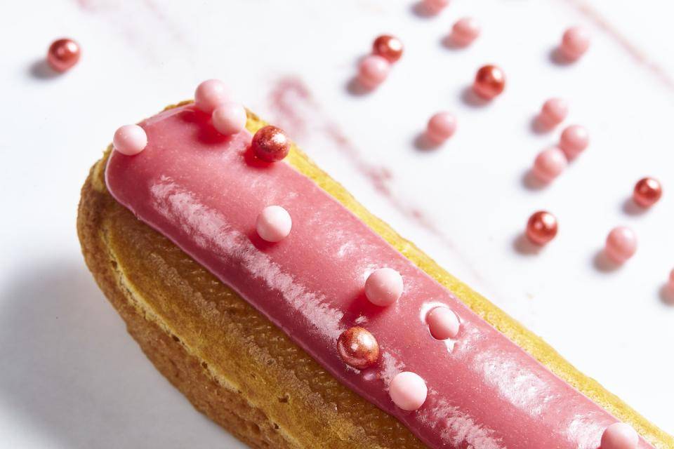 An eclair with a Ruby chocolate glaze and pink Crispearls