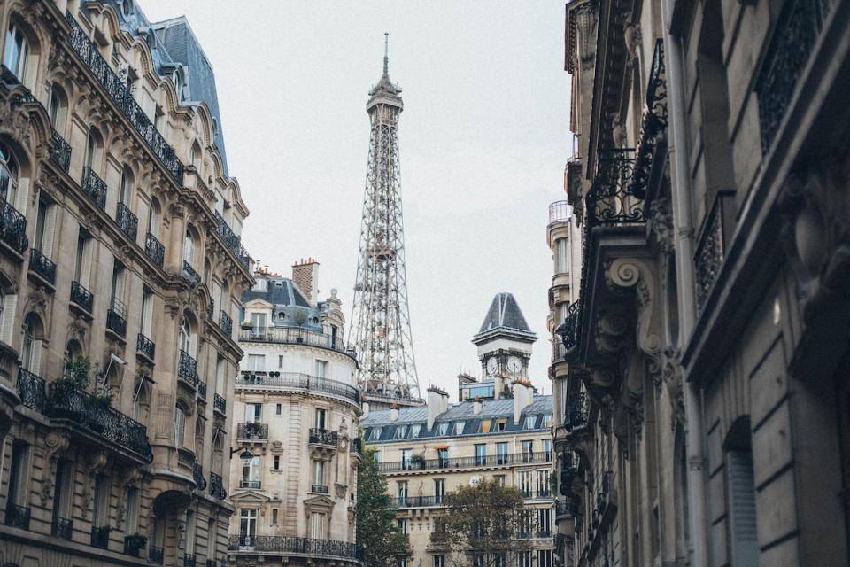 The Eiffel Tower peaks over the tops of Paris residences