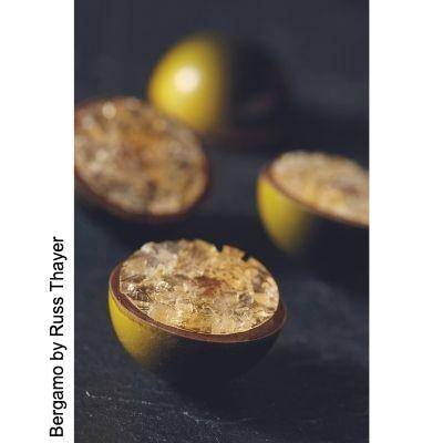 Molded bonbons shown upside-down with candied zest bottoms