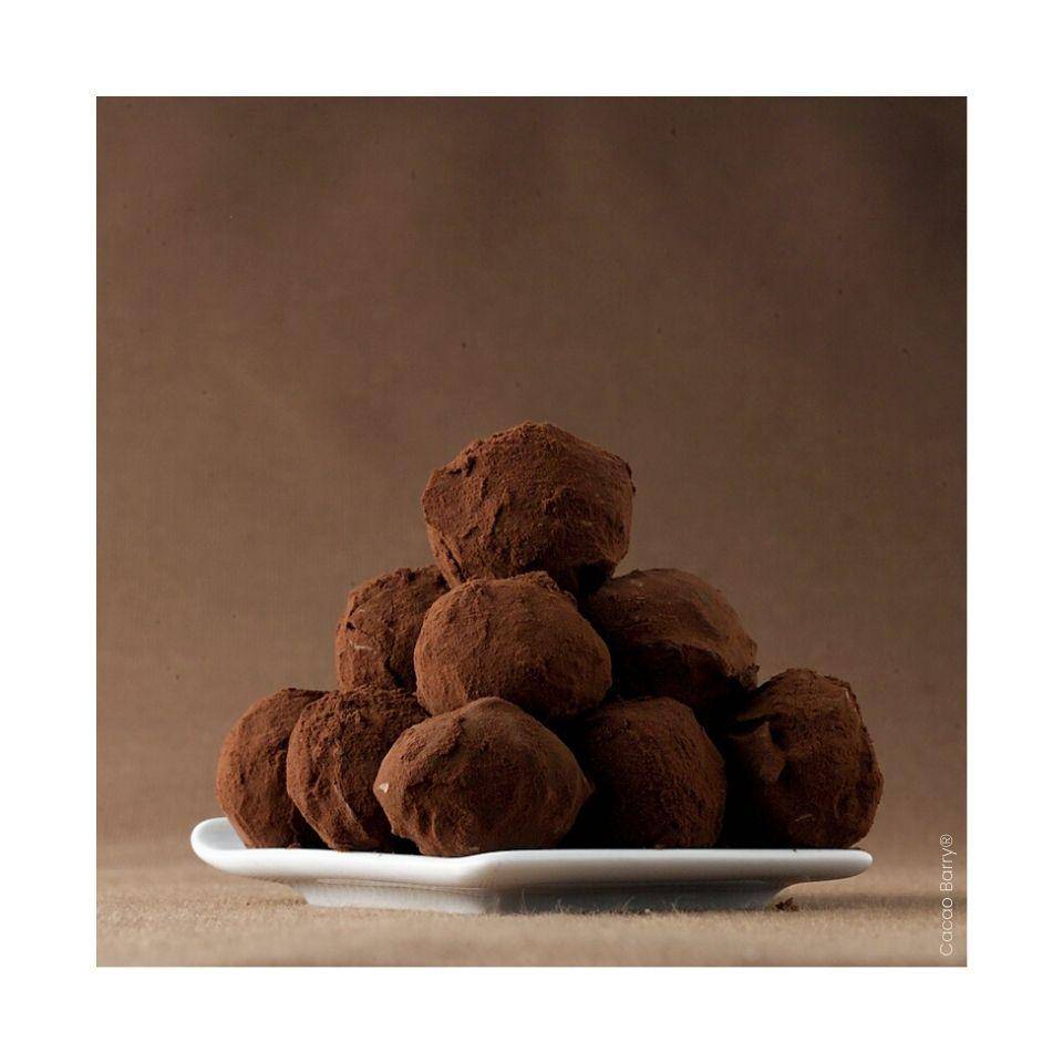 Dark Chocolate truffles piled on a square white plate