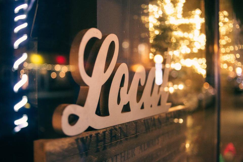 The word "Local" in 3-D script as sign in shop window