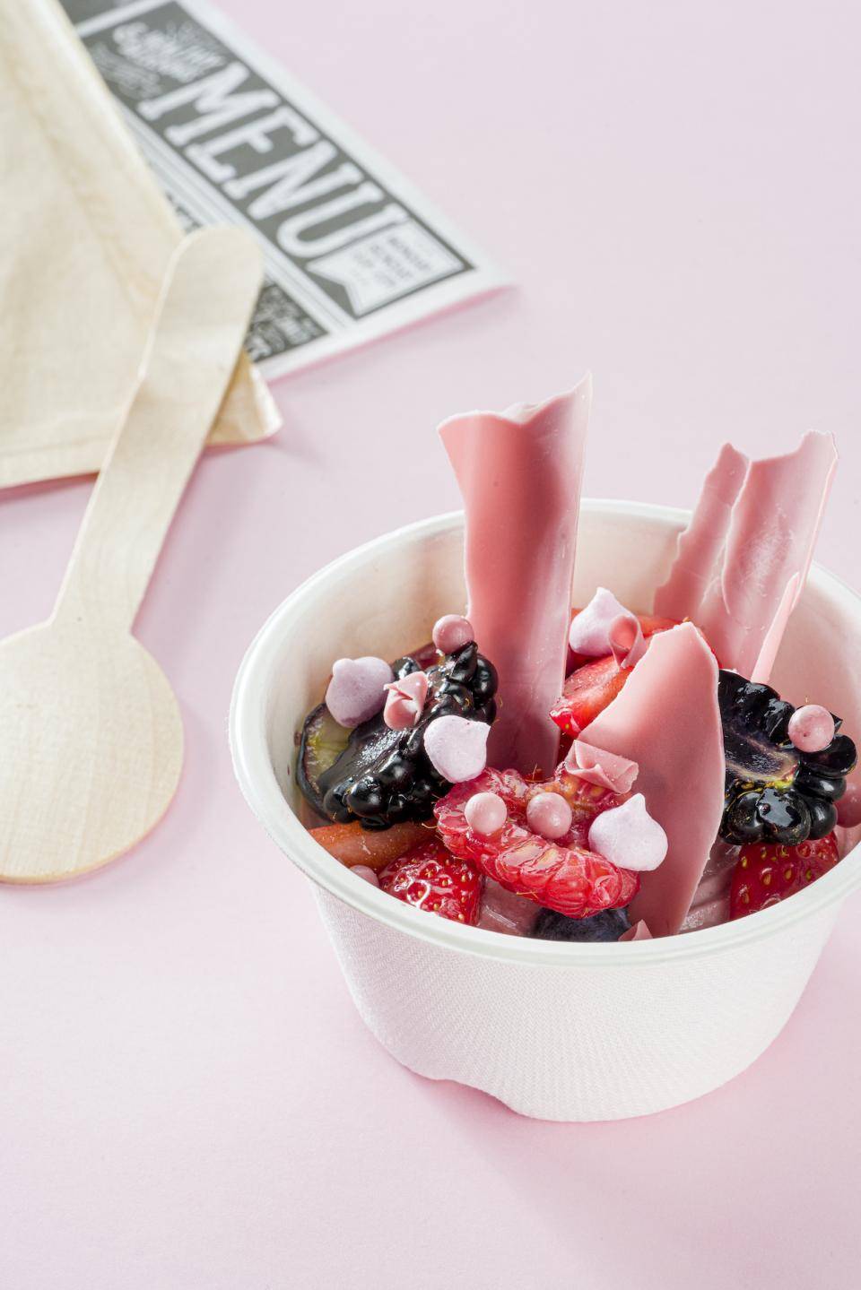 Small chocolate and berry dessert with shards of Ruby chocolate in a bowl