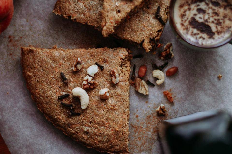 An earthy, natural brown color cake topped with walnuts