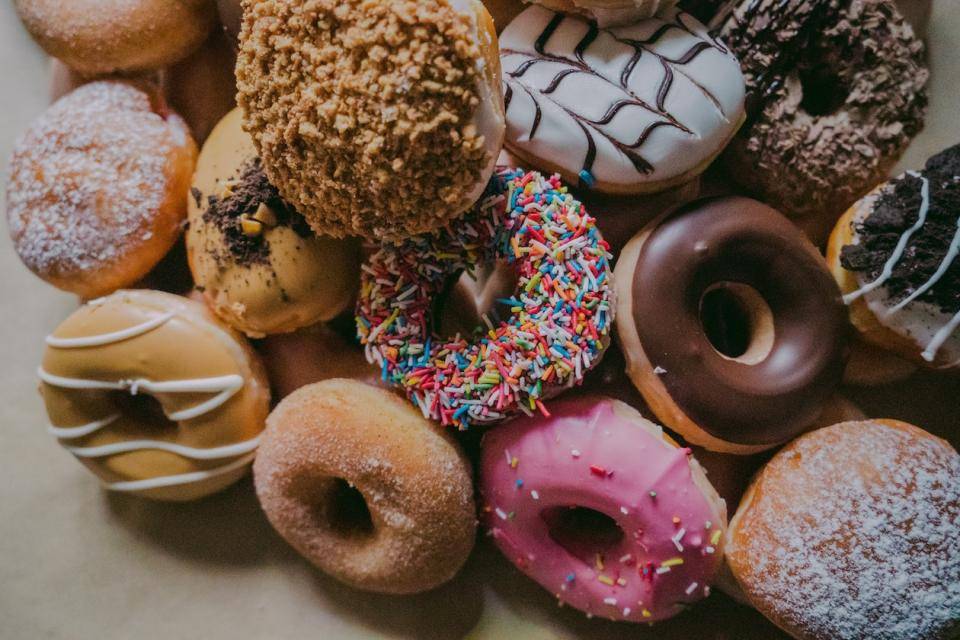 A variety of donuts spilling out onto a tabletop
