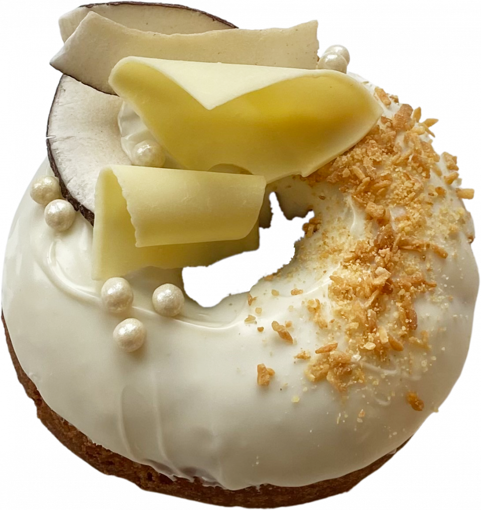 Fancy donut frosted with white chocolate and garnished with chocolate curls, coconut, and Crispearls™