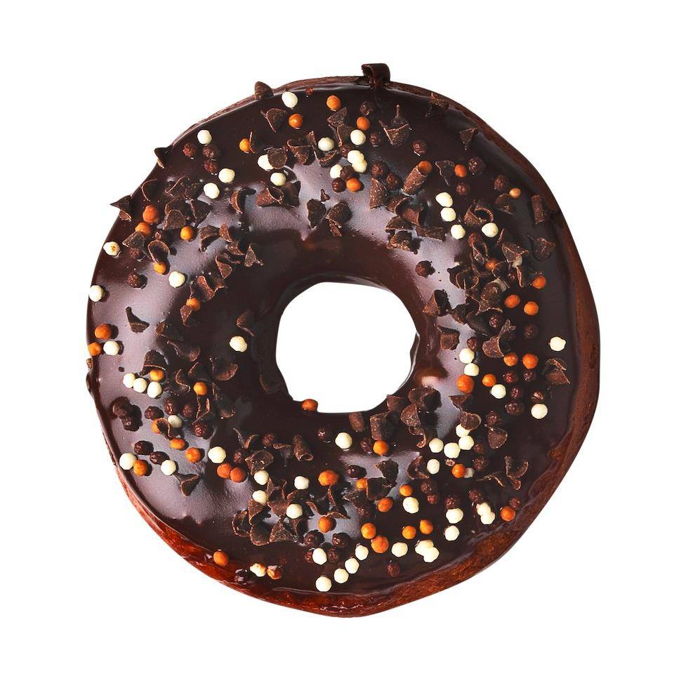 A shiny, glazed chocolate donut garnished with nonpareils