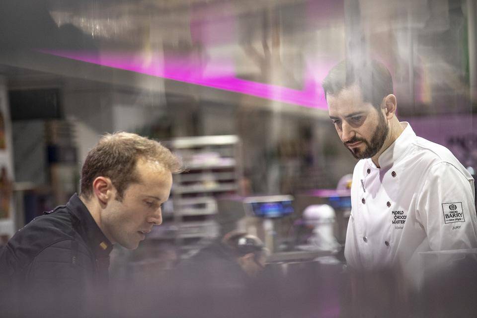 Chef Alistair Birt watching WCM finalist Lluc Crusellas at work