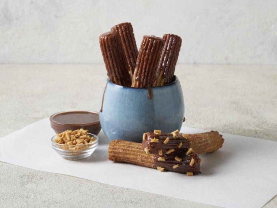 A bowl of chocolate-dipped churros
