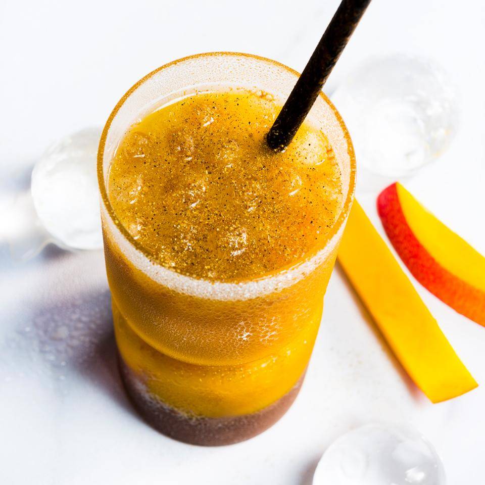 A mango beverage with a sugared/spiced rim
