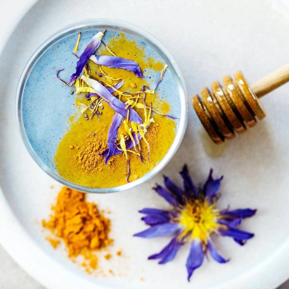 A blue beverage made with Butterfly Pea and garnished with turmeric