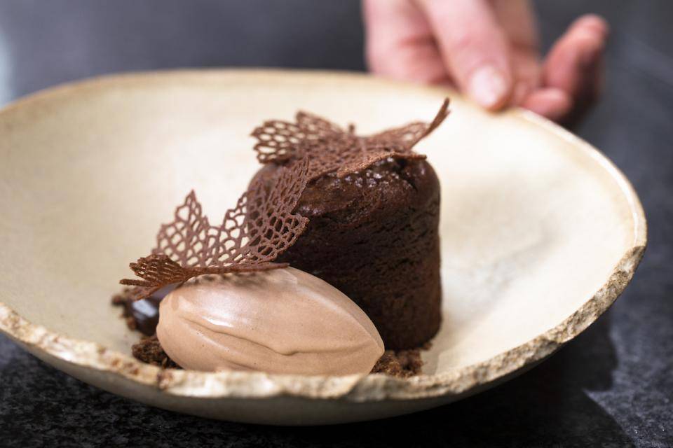 A Vegan plated dessert with plant-based cake and NXT milk chocolate ice cream