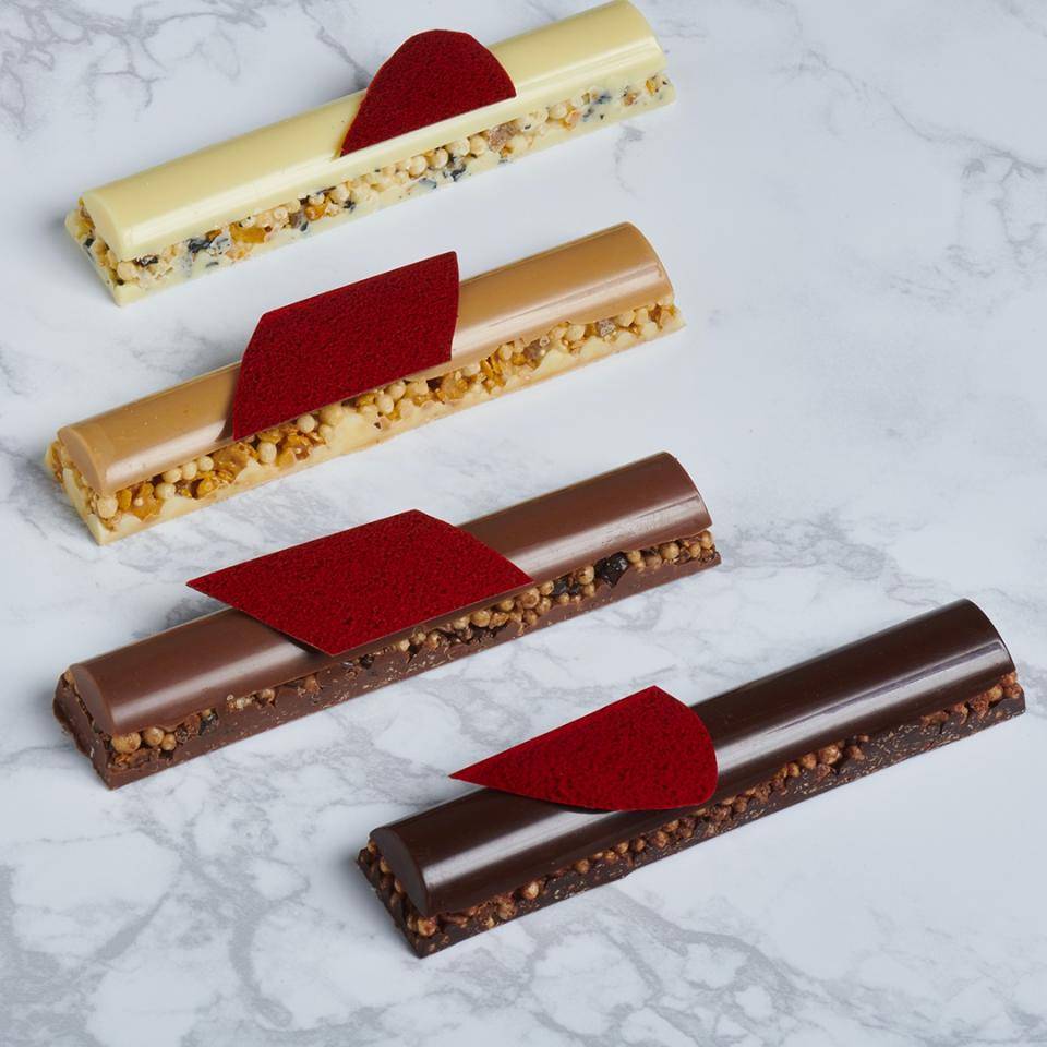 Side view of four Valentine's bars made from four colors of chocolate