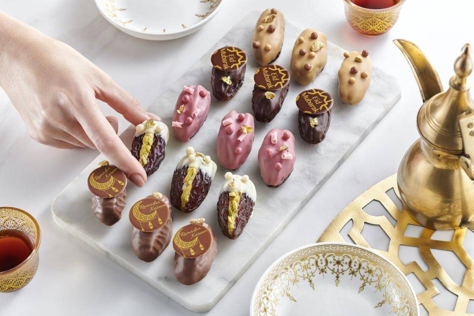 Dates dipped in chocolate with various garnishes
