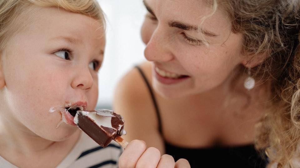 A small child enjoys an ice cream treat