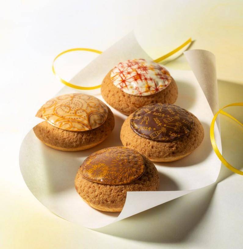 Choux buns topped with a round chocolate plaque