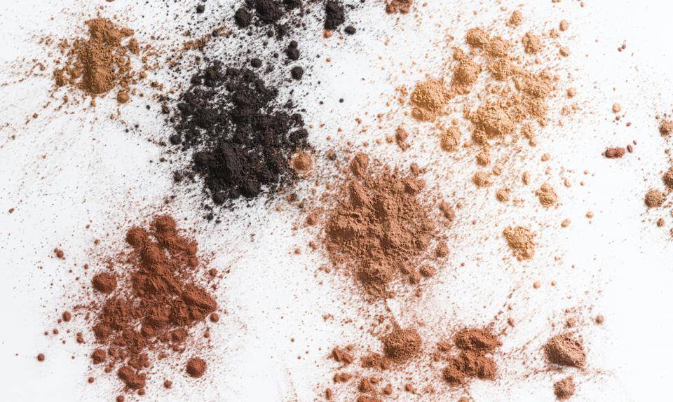 Different cacao powders dusted on a white surface