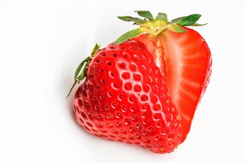 A fresh strawberry, cut in half