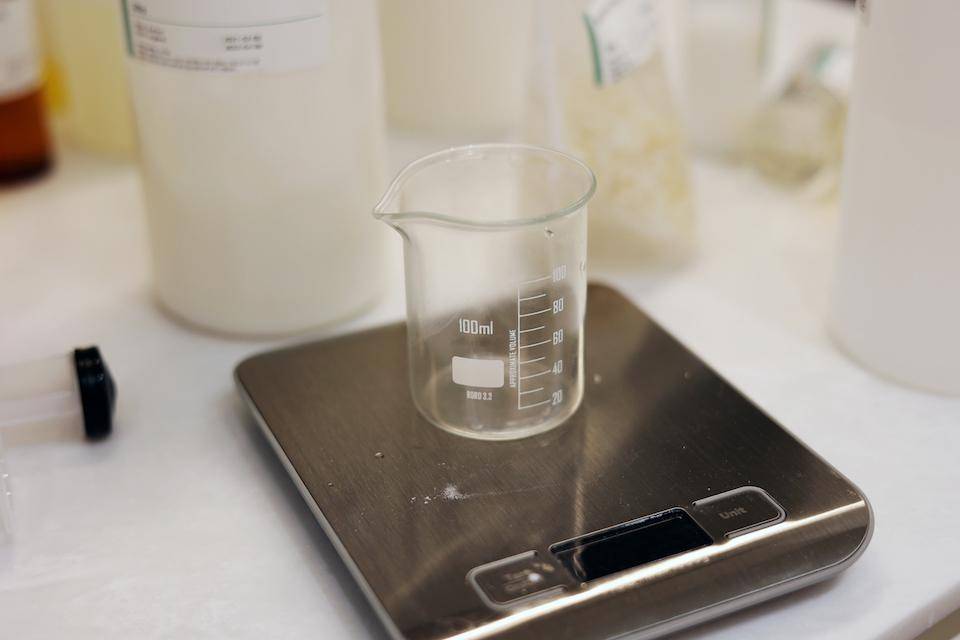 a glass beaker on a digital scale