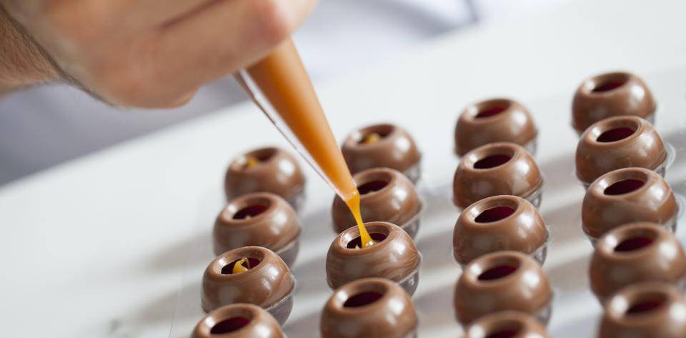 bonbon shells being filled with caramel