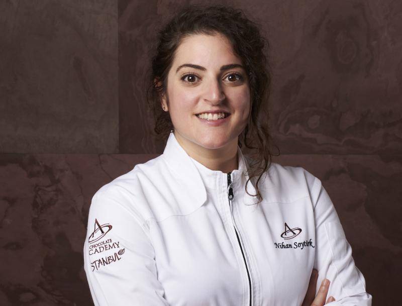 Pastry Chef and Chocolatier Chef Nihan Soyturk in a chef's jacket with the Chocolate Academy logo