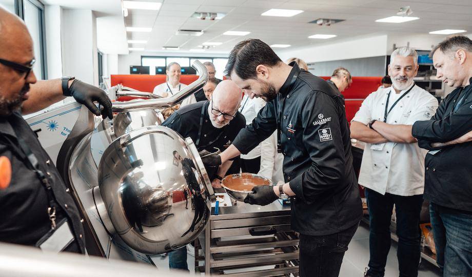 Alistair Birt, Mark Tilling, and chefs working with a Panning Machine at Selmi Headquarters
