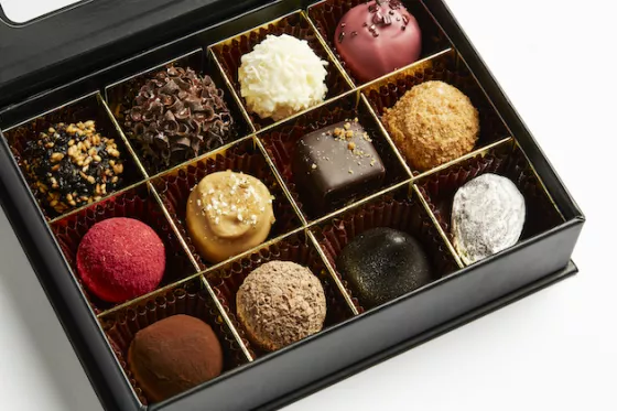 close-up of a box showing 6 different chocolate truffles