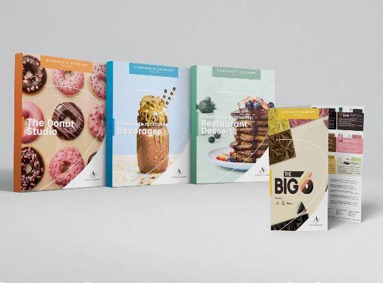 Chocolate Academy™ Presents Materials showing donuts, beverages, pancakes, and chocolate tablets