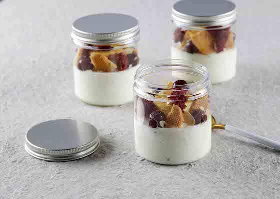 Single-serving desserts in jars featuring nuts and dried fruits