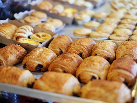 A Bakery Case with Croissants and other pastry