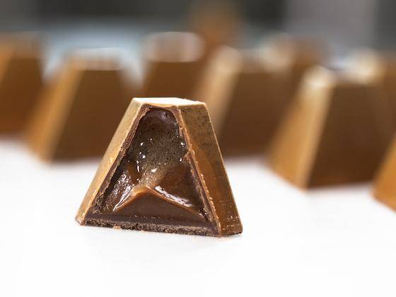 A caramel and chocolate bonbon made with Callebaut NXT plant-based chocolate